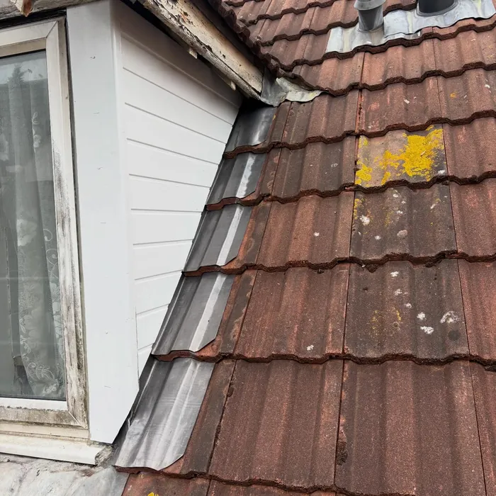 New white tongue and groove soffit on a dormer with code 4 lead soakers against the tiles